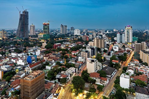 Evening city view with illuminated buildings and street lights, the skyline of Colombo in Sri Lanka