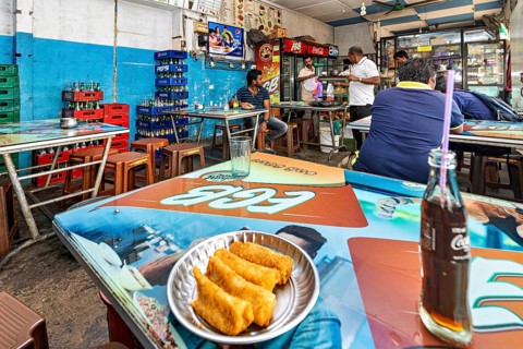 Casual snack with colorful tables and chairs, relaxed atmosphere, food and drinks on the tables,