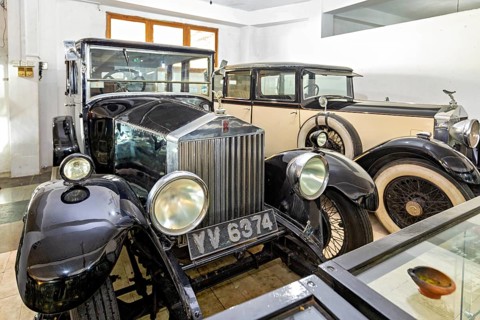 Black classic cars in a museum room, polished look, early automotive history design, classic car in