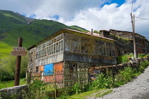 Rustic house on a mountainside under a cloudy sky, traditional house, Ushguli, Shibiani district,