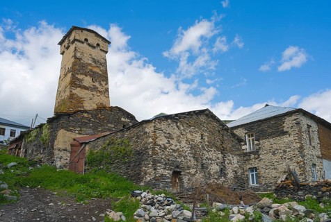 Old stone ruin with defence tower against a cloudy sky, defensive tower, Ushguli, Shibiani