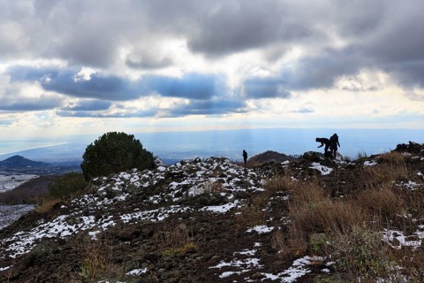 Barren volcanic landscape with remnants of snow, hikers, Etna, Etna, Catania, Sicily, Italy