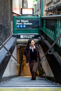 Young businesswoman ascending the stairs from the new york city subway at 34 street penn station,