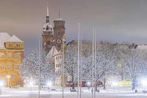 Winter in Stuttgart. The city is wintry white early in the morning. Castle square with collegiate