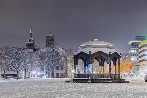 Winter in Stuttgart. The city is wintry white early in the morning. Palace Square with bandstand