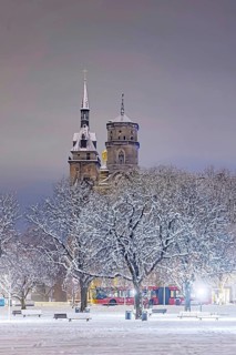 Winter in Stuttgart. The city is wintry white early in the morning. Castle square with collegiate