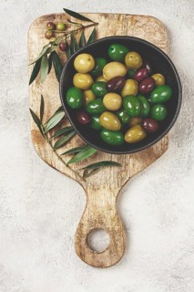 A mixture of olives, varieties of chalkidiki, Verdi giganti and Kalamata, in a bowl, top view, no