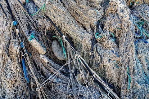 Close-up view of old fishing net hanging on boat, Oman