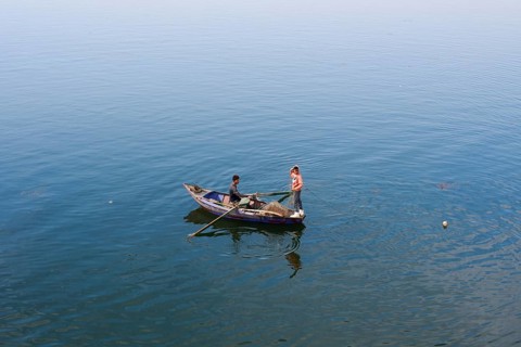 Boys in a rowboat fishing on the Nile, Luxor, Egypt