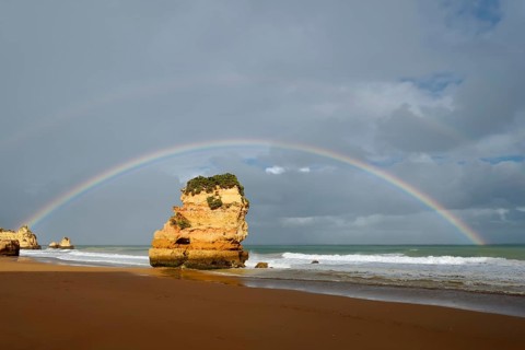 Rocks on beach with rainbow, Praia Dona Ana, Lagos, Algarve, Portugal