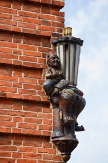 Lantern and sculpture on a house wall, Plön, Holsteinische Schweiz nature park Park,