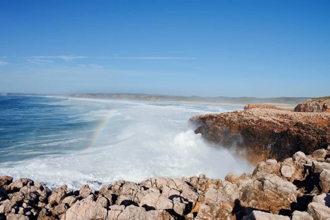 Surf with rainbow on the rocky coast, Carrapateira, Parque Natural do Sudoeste Alentejano e Costa