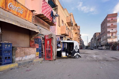 Street and a parked tuk-tuk in front of a shop, Esna, Egypt