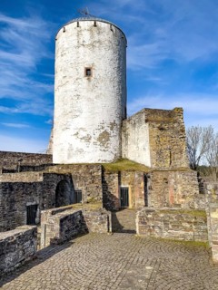 View of castle tower Bergfried made of stone masonry of castle ruins of medieval Höhenburg