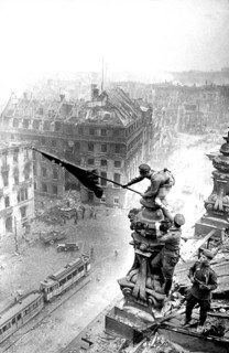 At the Berlin Reichstag, May 2, 1945, three Soviet soldiers fly the flag of the Soviet Union. The