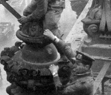 Excerpt from the photo: At the Berlin Reichstag, May 2, 1945, three Soviet soldiers hoist the flag
