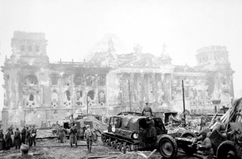 Soviet soldiers with military equipment in front of the destroyed Reichstag, early May 1945,