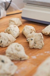 Several small pieces of dough lie on a wooden table to prepare, bake rolls, Haselstaller Hof,