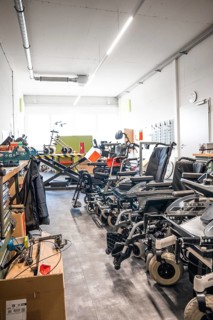 Spacious workshop with wheelchairs and rehabilitation equipment, clean and modern, medical supply