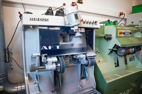 Industrial grinding machine in a metalworking workshop, medical supply store