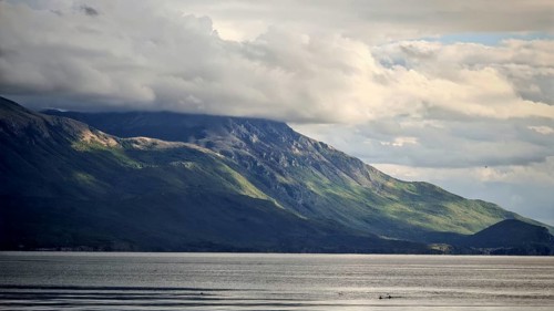 Dramatic mountain landscape with cloudy sky and calm lake in the foreground, Lake Ohrid, North