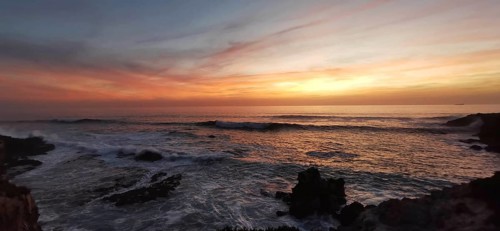 Sunset on the fishing trail over the sea with calm waves and colorful skies, Southwest Alentejo