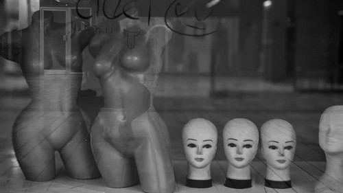 Shop window with mannequins and heads in a melancholy black and white atmosphere, Skopje, Macedonia