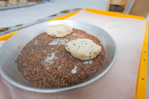 Two dough pieces lie in a flat metal bowl with linseeds, bake rolls, Haselstaller Hof, Gechingen,