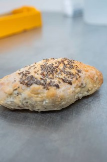 Crispy baked roll with seeds on a metal surface, bake rolls, Haselstaller Hof, Gechingen, Germany