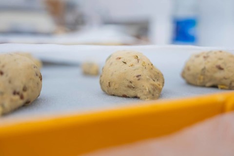 Close-up of unbaked dough pieces on a yellow tray, kitchen, baking rolls, Haselstaller Hof,