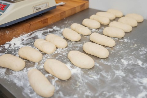 Rollbread dough pieces on flour-dusted table, ready for baking, baking rolls, Haselstaller Hof,