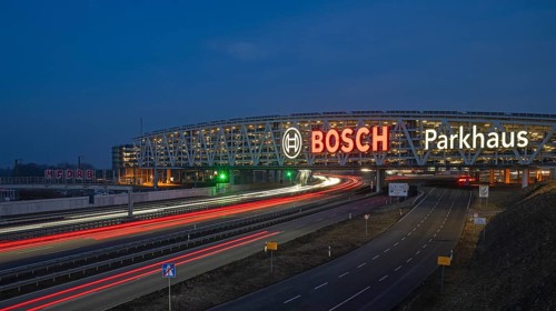 Traffic on the A8 motorway, blue hour, illuminated parking garage, Landesmesse Stuttgart, red-lit