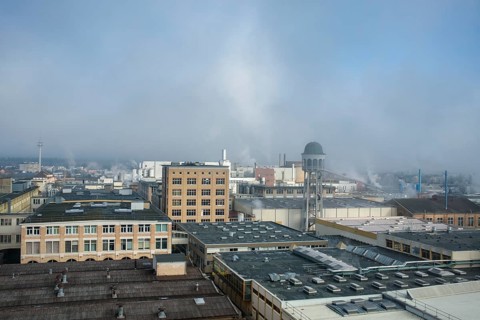 View of the industrial area of Singen am Hohentwiel with industrial buildings and hazy morning sky,