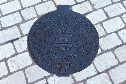 Manhole cover with the coat of arms of Krakow, Krakow, Poland