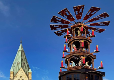 Christmas market with mulled wine pyramid and the tower of Paderborn Cathedral, Ostwestfalen-Lippe,
