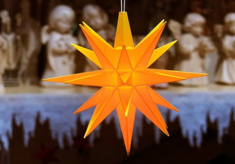 Glowing Christmas star in front of angel figures at the Christmas market, detail, Paderborn,