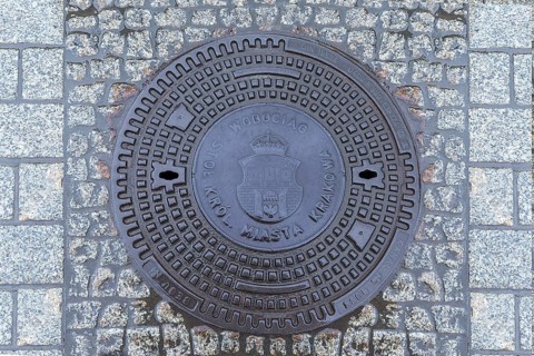 Manhole cover with the coat of arms of Krakow, Krakow, Poland