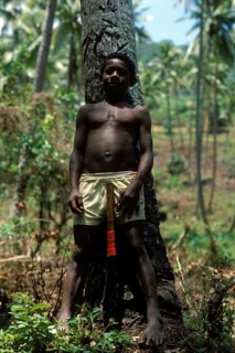Boy with a machete in front of a kocus palm, Tavewa island, Yasawa archipelago, Fiji