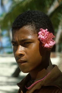 Boy with flowers behind left ear, Tavewa Island, Yasawa archipelago, Fiji