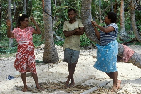 Local 2 woman and a man standing on the beach, Tavewa island, Yasawa archipelago, Fiji