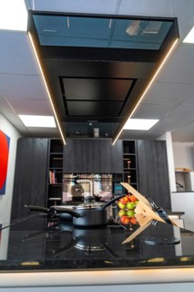 Elegant kitchen with black work surface and stylish decor