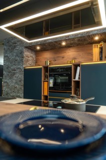 Detail of a modern kitchen with brick wall and elegant decoration