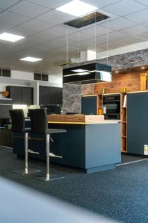 Detail of a modern kitchen with brick wall and stylish lighting