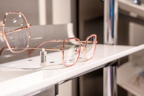 Elegant rose gold glasses presented on a modern shelf, optician, Pforzheim