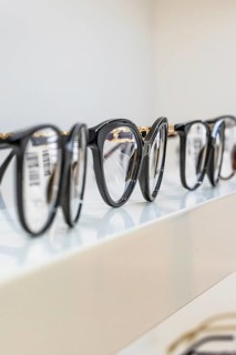Several black eyeglass frames on a shelf in an optician's shop, optician, Pforzheim