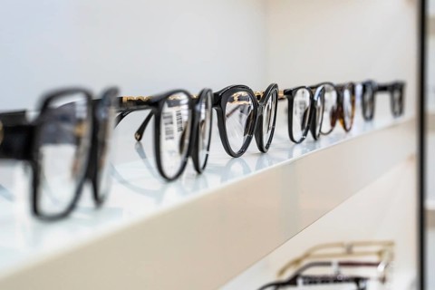 Row of eyeglass frames on a shelf in an optician's shop, optician, Pforzheim