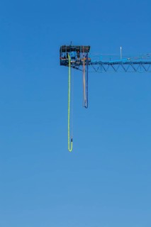 Montreal Bungee Tower installation with dangling long yellow elastic bungee jumping cord, Old Port