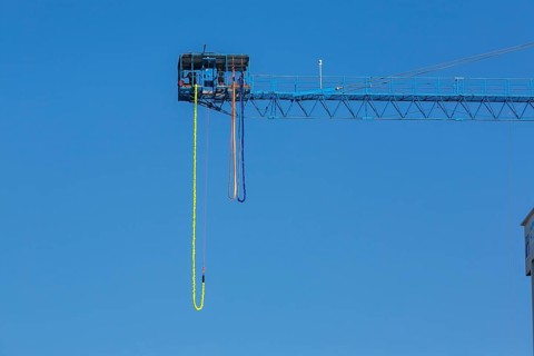 Montreal Bungee Tower installation with dangling long yellow elastic bungee jumping cord, Old Port