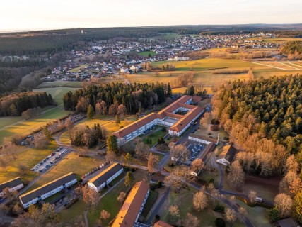 Buildings and fields surrounded by forest at dusk of a rural scene, rehab clinic, Schömberg, Black