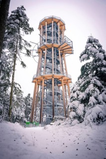 A snowy treetop trail against a winter sky under snow-covered trees, Himmelsglück observation tower